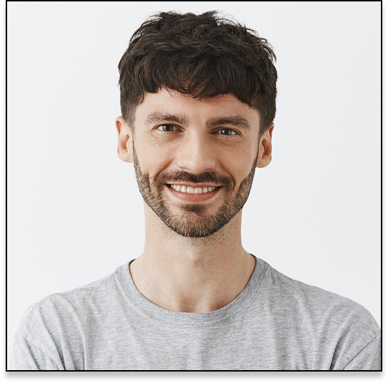 A young smiling man with a disheveled hairstyle